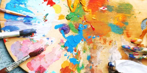 A palette with every color of the rainbow splattered on it! 