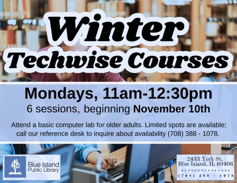 A young man guides a patron in using the computer